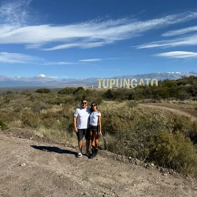 Couple at the Tupungato sign with the Andes behind